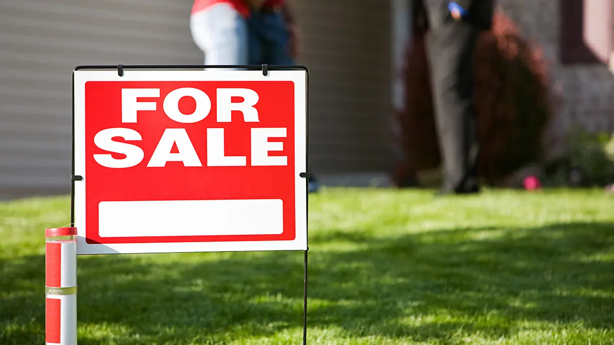 Home: For Sale Sign with Agent and Couple in Back